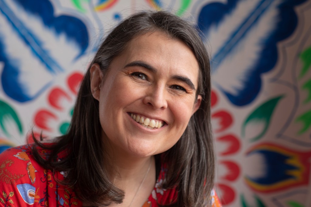 Author Sara Fajardo in front of a retablo