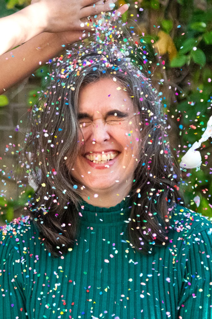 Photo of author Sara Fajardo getting a cascarón smashed on her head.
